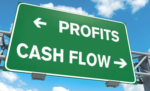 Freeway Sign With Profits Headed To The ;left And Cash Flow Headed To The Right