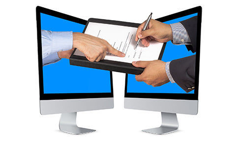 Hands Extending From Two Monitors To Sign A Contract