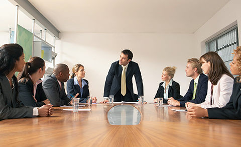 Professionals Sitting Around A Table In A Business Meeting