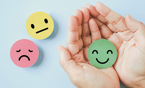 Stickers With Happy Face, Sad Face, Neutral Face. Hands Holding The Happy Face Sticker