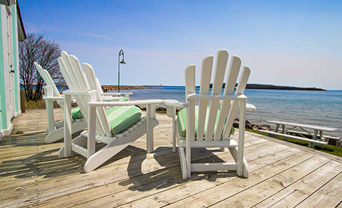 Beach Chairs On A Deck Near The Ocean