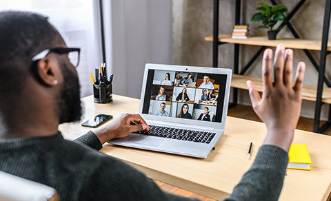 Young Man At A Desk On A Zoom Meeting