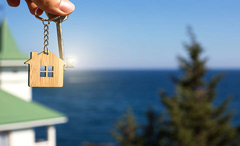 Beach View Withe A Rental Key Being Held In The Foreground