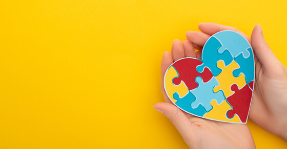 IRA charitable donations: An alternative to taxable required distributions Hands Holding A Heart Puzzloe On A Yellow Background