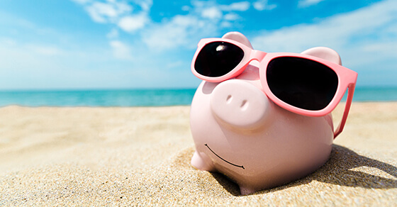 3 summertime marketing ideas for 2022 Piggy Bank Wearing Sunglasses In The Sand At Thr Beach