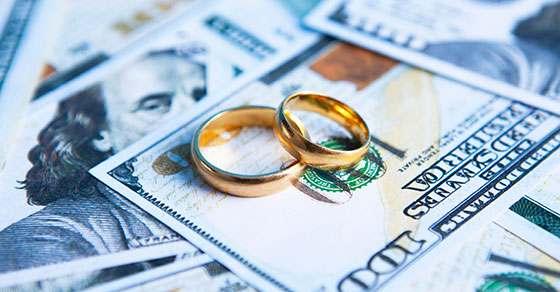 Wedding Rings On Top Of A Pile Of Cash