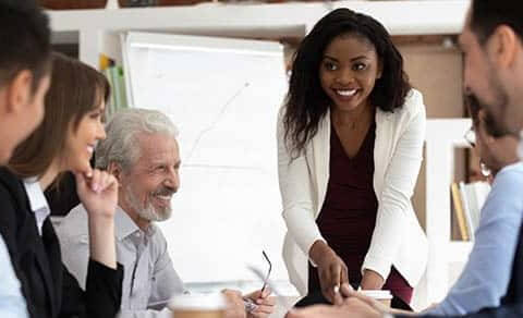 Diverse Businesspeople Gathered Together For Negotiations Lead By A Businesswoman