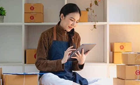 Beautiful Business Woman Owner Selling Online Using Tablet To Chat With Customer.