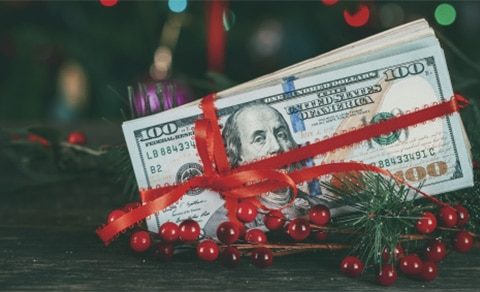 Dollar Wrapped In A Red Ribbon In Christmas Decorations.