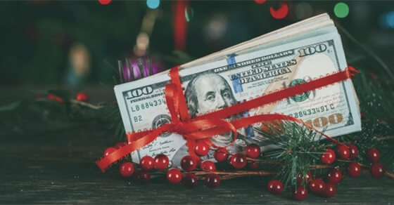 Dollar Wrapped In A Red Ribbon In Christmas Decorations.