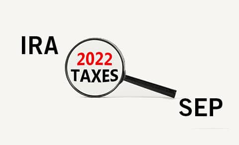 Magnifying glass enlarging the words 2022 TAXES