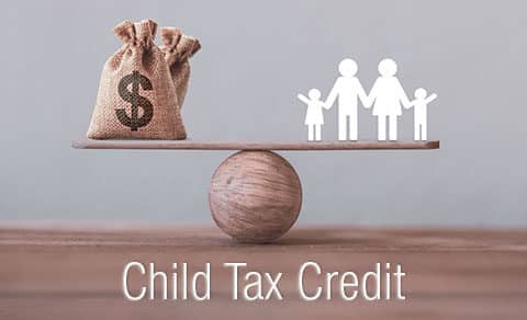 Child Tax Credit title - Cut out family of paper dolls and sack of money balancing on a wooden ball