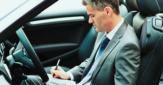 Businessman,sitting,in,his,car,,he,is,planning,and,scheduling