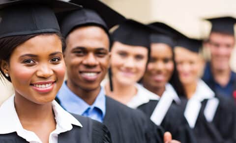 Colleger Graduates in cap and gown all in a row