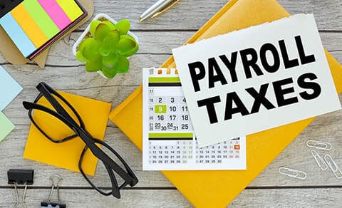 Payroll,taxes,.,multicolored,stickers,and,yellow,notepad,with,notepad