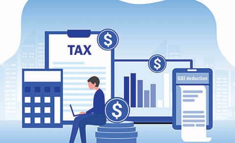 Illustration of a man sitting in a chair working on his laptop with a calculator, clipboard with the word TAX on it, a graph, and a notepad