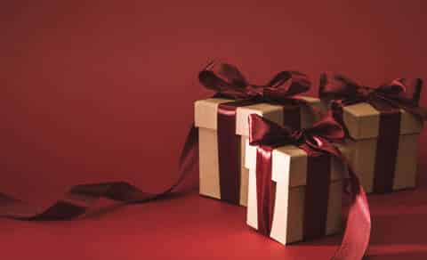 3 gifts with red bows on a red background