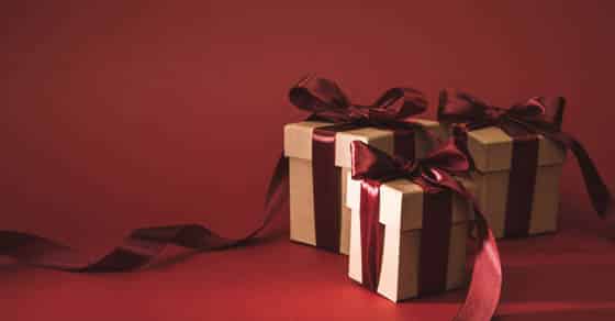 3 gifts with red bows on a red background