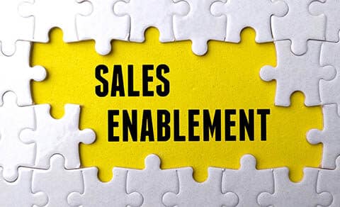 Text,sales,enablement,written,on,yellow,background,with,white,puzzle.