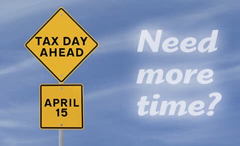 Blue sky with clouds, yellow yield street sign that says Tax Day Ahead April 15, Need more time written in the sky