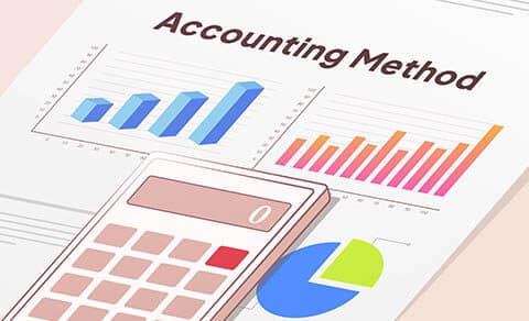 Accounting Method report with bar graphs on it, browan and white calculator on top of it.