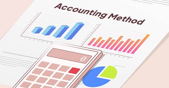 Accounting Method report with bar graphs on it, browan and white calculator on top of it.