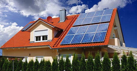 Outside of a house with orange roof that has solar panels