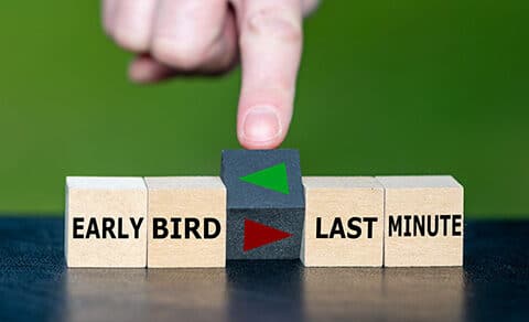 ooden blocks labeled "EARLY, BIRD," and "LAST, MINUTE," with a hand rotating a cube. A green, arrow, points, to, "EARLY, BIRD," and a red, arrow, points, to, "LAST, MINUTE," symbolizing a choice, between, acting, early, or, waiting.