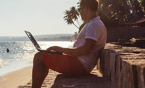 Man,on,beach,with,laptop,,vietnam,,mui,ne