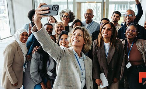 A,diverse,group,of,professionals,taking,a,cheerful,selfie,together