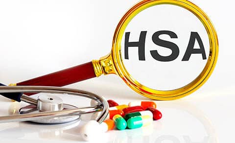Magnifying,lens,with,text,hsa,with,medical,tools,pills