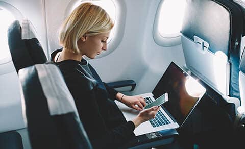 Businesswoman,with,short,haircut,sitting,in,airplane,cabin,and,chatting