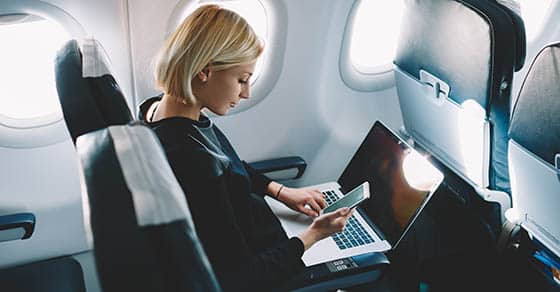 Businesswoman,with,short,haircut,sitting,in,airplane,cabin,and,chatting