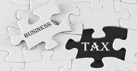 A, puzzle, with, a, missing, piece,, where, the, visible, black, space, reads, 'TAX,' and, the, puzzle, piece, being, placed, reads, 'BUSINESS,' symbolizing, the, connection, between, business, and, taxes.
