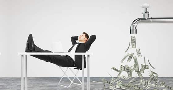 Businessman,resting,on,a,chair,and,faucet,from,which,the