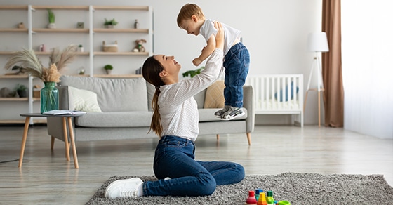 Mother, playing, with, her, young, son, bright, living, room, soft, natural, light, cozy, and, modern, decor, toys, on, the, rug, joyful, moment.