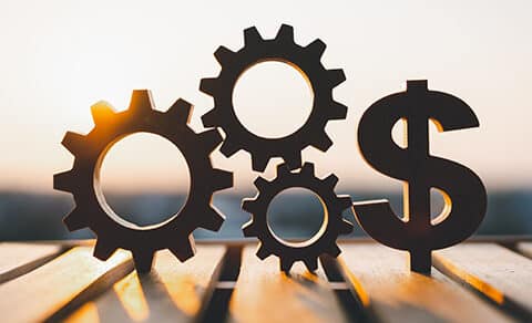 ChatGPT said: Silhouettes, of, three, interlocking, gears, and, a, dollar, sign, symbolizing, business, finance, and, operational, efficiency, with, a, warm, sunrise, or, sunset, in, the, background.