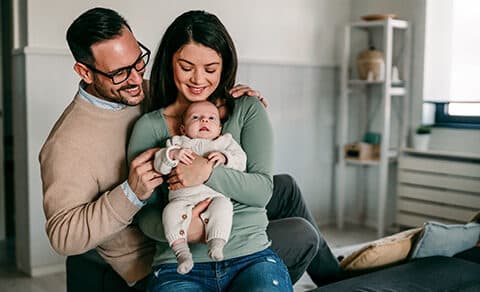 Based, on, the, image, of, a, smiling, couple, holding, their, baby, in, a, cozy, home, setting,, the, article, it, accompanies, likely, falls, into, one, or, more, of, the, following, categories,