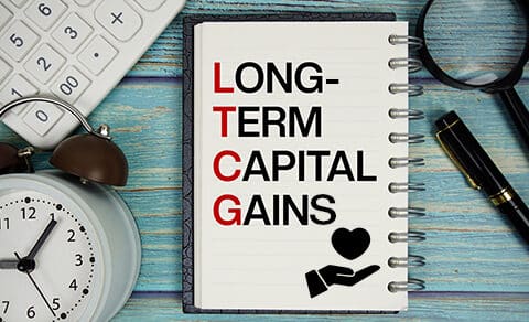 Notebook, LTCG, Long-Term, Capital, Gains, heart, hand, calculator, magnifying, glass, pen, clock, finance, tax, planning.