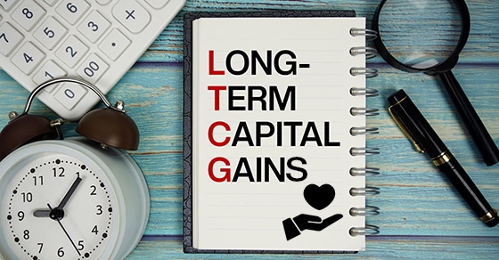 Notebook, LTCG, Long-Term, Capital, Gains, heart, hand, calculator, magnifying, glass, pen, clock, finance, tax, planning.