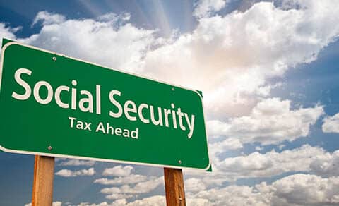 Social,security,green,road,sign,over,dramatic,clouds,and,sky.