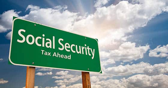 How the Social Security wage base will affect your payroll taxes in 2026 Social,security,green,road,sign,over,dramatic,clouds,and,sky.