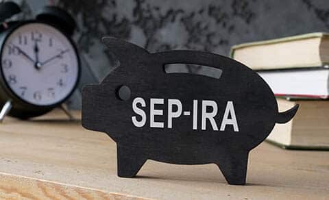 Wooden,piggy,bank,with,sep,ira,inscription,on,the,side.