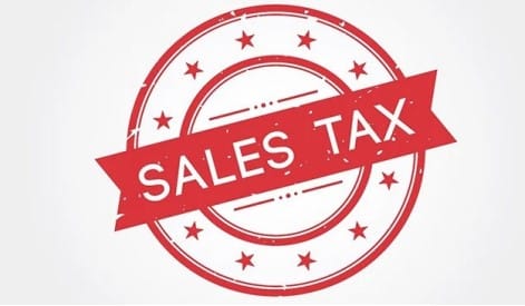 A, red, circular, stamp-style, graphic, with, stars, around, the, border, and, a, banner, across, the, center, that, reads, SALES, TAX,